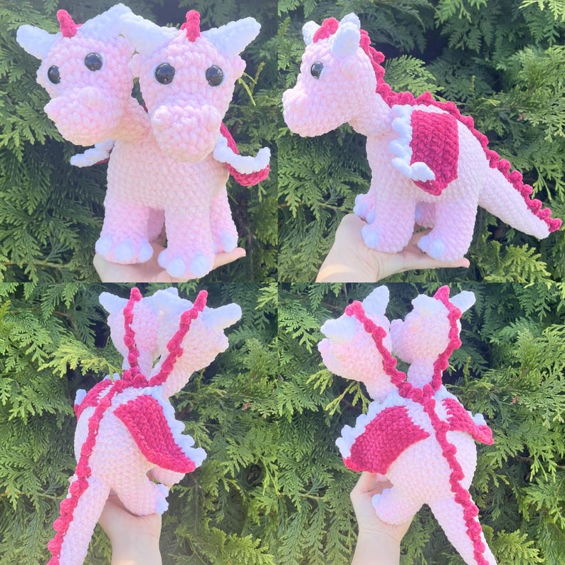 May include: Crocheted pink dragon plushies with white accents. One dragon has two heads, the other has one. The dragons have red spines and wings. The plushies are handmade and have black eyes.