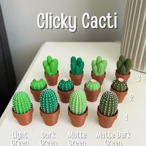 May include: A collection of miniature cactus figurines in small brown pots. The cacti come in various shades of green, including light, dark, and matte finishes. The text "Clicky Cacti" is displayed at the top.