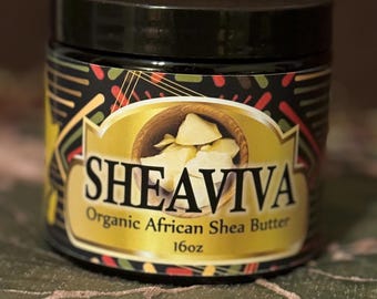 May include: A black jar with a gold label that reads "SHEAVIVA Organic African Shea Butter 16oz". The label has a colorful geometric pattern and a picture of shea butter in a wooden bowl.