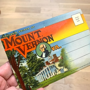 May include: A vintage postcard featuring a colorful illustration of Mount Vernon, Virginia. The postcard includes a portrait of George Washington and a view of the mansion and grounds. The text on the postcard reads "Souvenir Folder of Mount Vernon, VA. East View of Mansion and Grounds."