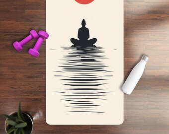 May include: A white yoga mat with a black silhouette of a person meditating on a body of water with a red circle above. The water is depicted with black lines that create a ripple effect.