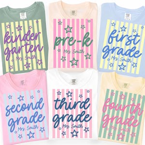 May include: Six t-shirts in sage green, peach, light blue, pink, white, and yellow. Each features a vertical striped rectangle with stars and text reading kindergarten, pre-k, first grade, second grade, third grade, or fourth grade, plus Mrs. Smith.