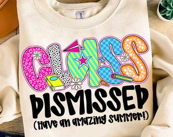 May include: A beige sweatshirt with the words "Class Dismissed (Have an amazing summer!)" printed on it. The word "Class" is in colorful, playful letters with various patterns and designs.