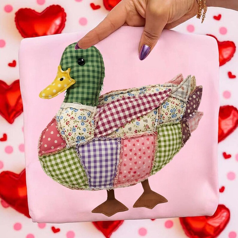 May include: A patchwork duck with a green checkered head and a yellow beak. The duck's body is made of various fabric patterns, including polka dots, floral prints, and gingham. The duck is set against a pink background.