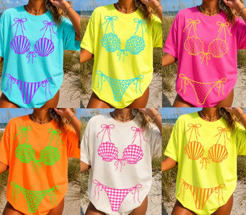 May include: A selection of t-shirts with bikini designs in various colours. The shirts are available in light blue, yellow, pink, orange, and cream. Each shirt features a different bikini design, some with seashell or gingham patterns.