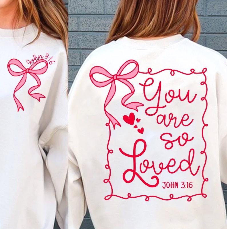 May include: White sweatshirt with a pink bow and the text "You are so Loved" in a red frame with hearts and the text "John 3:16" below.