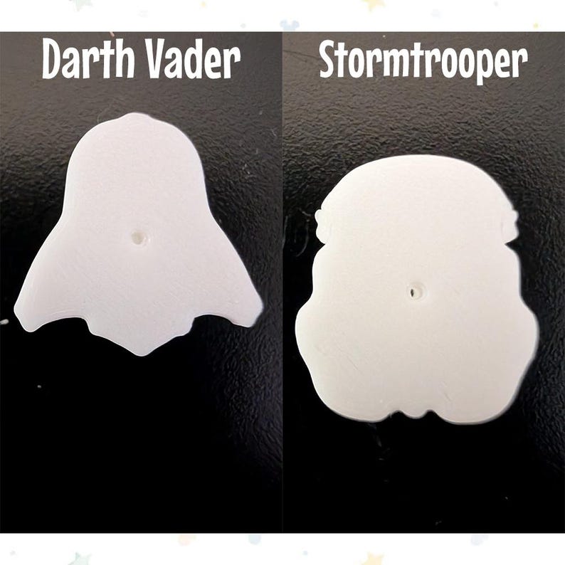 Op de afbeelding: Twee witte, gestileerde karakteruitsparingen, &eacute;&eacute;n die op Darth Vader lijkt en de andere op een Stormtrooper-helm. De tekst "Darth Vader" en "Stormtrooper" staan boven elke uitsparing. De uitsparingen staan op een zwarte achtergrond.