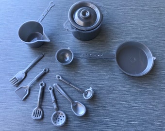 May include: A set of 10 gray plastic toy kitchen utensils, including a pot, pan, measuring cup, and various spoons and spatulas.