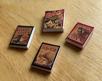 May include: Four vintage paperback books with colorful covers. The books are titled "The G-Man", "Ellery Queen", "Captain Frank Hawks", and "Jack Armstrong".