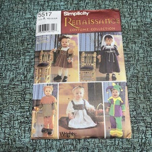 May include: A Simplicity 5517 Renaissance Costume Collection sewing pattern envelope for children's sizes A 1/2, 1, 2, 3, 4. The front displays five photographs of children wearing various historical-style costumes, including tunics, dresses, and a jester outfit.