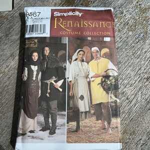 May include: A Simplicity 8587 Renaissance Costume Collection sewing pattern envelope. The front displays four individuals wearing historical-style garments, including tunics, vests, aprons, and head coverings, with text labels A, B, C, and D.
