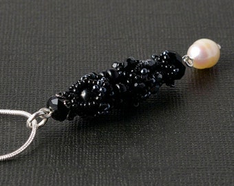 beadwoven black pendant with white pearl drop