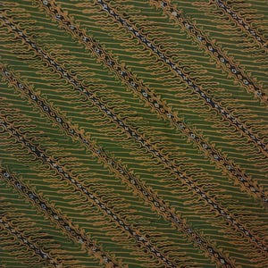 May include: Green fabric with a repeating pattern of gold and black wavy lines and diamond shapes.