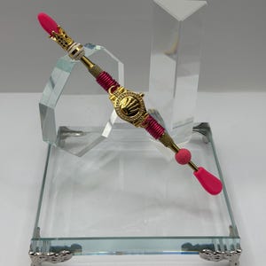 This unique custom-made super-elegant ear spoon is a scoop for condiments, Glitter, Mica powder, etc. (Rolex) Gold Metal- Fucsia cable.