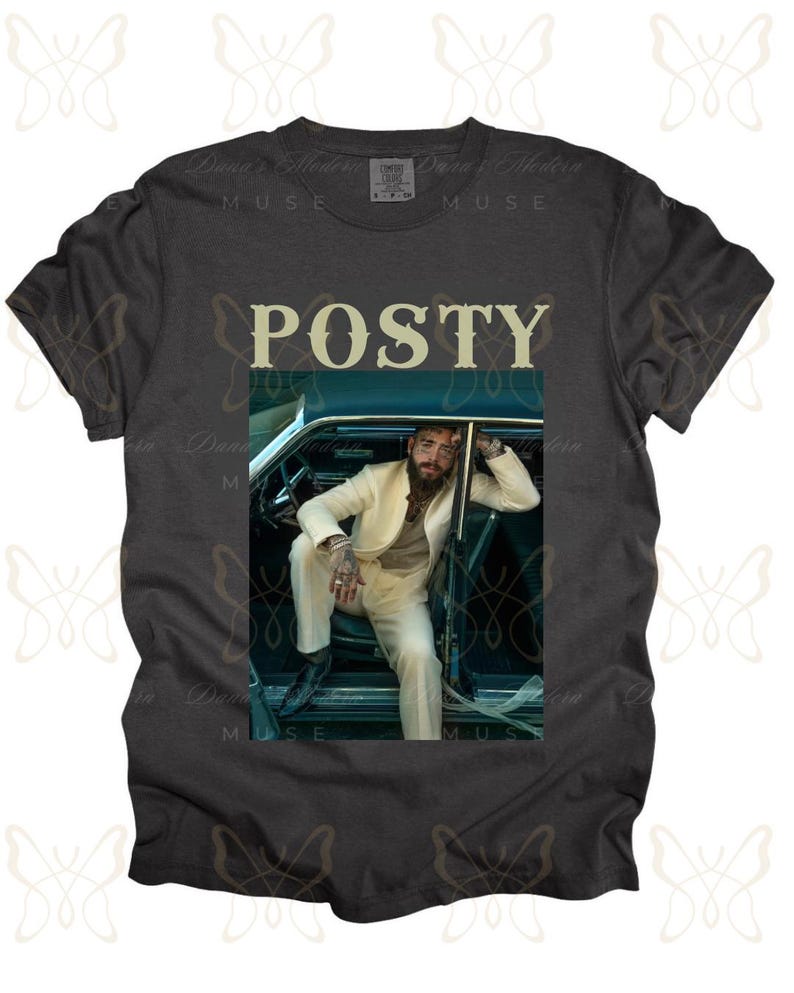 May include: A dark gray t-shirt with a white graphic of a man in a white suit sitting in a car. The text "POSTY" is printed in white above the graphic.