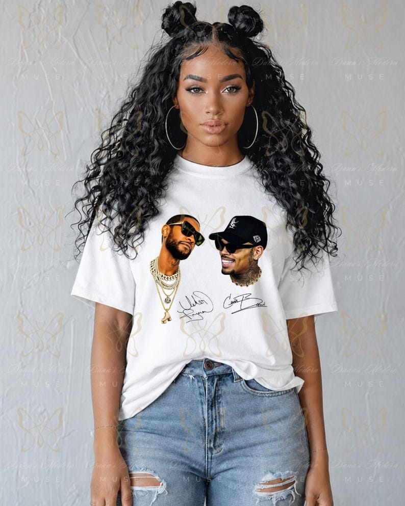May include: A white short-sleeve t-shirt featuring a graphic print of two men wearing sunglasses and jewelry, accompanied by two handwritten-style signatures. The shirt is paired with light blue denim jeans that have distressed knee detailing.