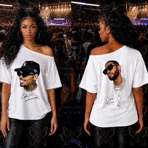 May include: A white off-the-shoulder t-shirt featuring two distinct graphic prints. The front displays a portrait of a man wearing a black baseball cap and sunglasses with a signature. The back shows a portrait of a man with sunglasses and layered chains.