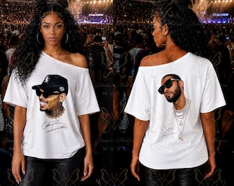 May include: A white off-the-shoulder t-shirt featuring two distinct graphic prints. The front displays a portrait of a man wearing a black baseball cap and sunglasses with a signature. The back shows a portrait of a man with sunglasses and layered chains.