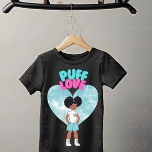 May include: Black t-shirt with a blue and white heart design featuring a cartoon girl with afro puffs. The text "Puff Love" is printed in pink and blue letters on the heart.