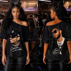 May include: A black off-the-shoulder t-shirt featuring a graphic print of a man wearing sunglasses and a chain, with a signature below. The image shows both the front and back views of the shirt, which displays a different portrait and signature.