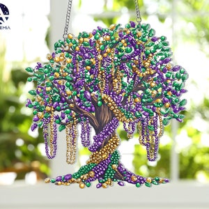 May include: A purple, gold, and green beaded tree ornament with a brown trunk and branches. The beads are arranged in a cascading pattern, resembling a Mardi Gras celebration.