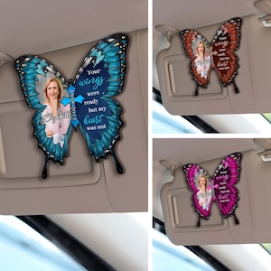 May include: A blue butterfly car sunshade with a photo of a person and the text "Your wings were ready but my heart was not".
