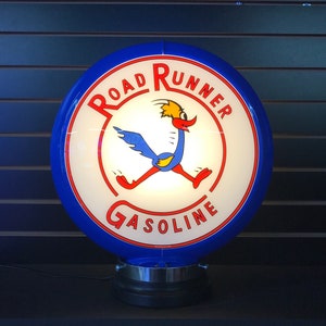 May include: A blue and white gas station globe sign with the words "Road Runner Gasoline" and a cartoon roadrunner running.