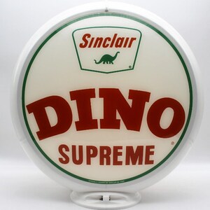 May include: A white, round Sinclair gas station sign with a green and red logo. The sign features the Sinclair logo with a green dinosaur and the words "DINO SUPREME" in red. The sign is officially licensed.