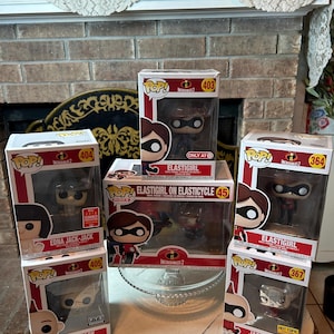 May include: A collection of Incredibles 2 Funko Pop! figures in their original boxes. The figures include Elastigirl, Jack-Jack, and Edna Mode. The boxes are red, white, and black.