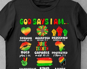 May include: Black t-shirt with the text "God Says I Am..." in white. The shirt features a variety of colorful images and text, including hearts, flowers, fists, lips, peace signs, and flags. The text includes bible verses and phrases like "Strong", "Accepted", "Redeemed", "Juneteenth", "Capable", "Protected", "Courageous", "Kind", and "Loyal".