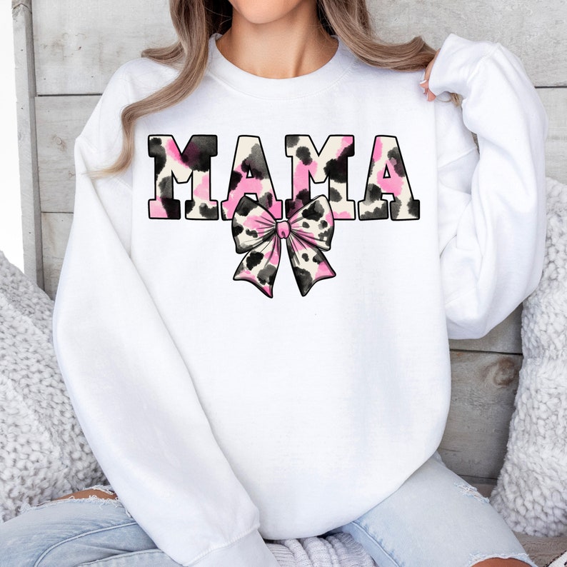 May include: White sweatshirt with the word "MAMA" in pink and black leopard print with a pink and black leopard print bow.