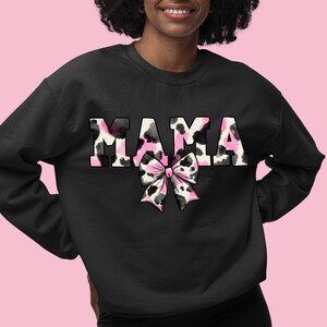 May include: Black sweatshirt with the word "MAMA" in pink and black cow print with a pink and black cow print bow.