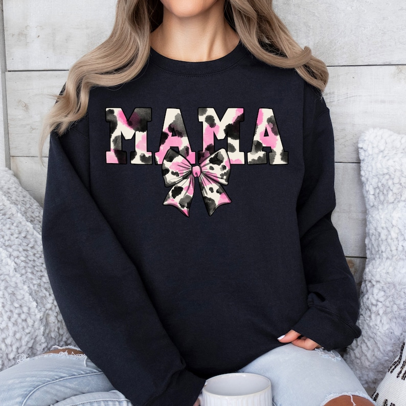 May include: Black sweatshirt with the word "MAMA" in pink and black leopard print letters with a pink and black leopard print bow.