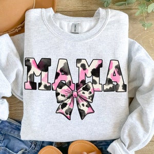 May include: A gray sweatshirt with the word "MAMA" in pink and black leopard print letters. A pink and black leopard print bow is centered below the word.