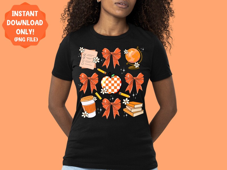 May include: A black t-shirt with a design of various school-themed items, including an apple, a globe, a pencil, a book, a coffee cup, and bows in orange and white.