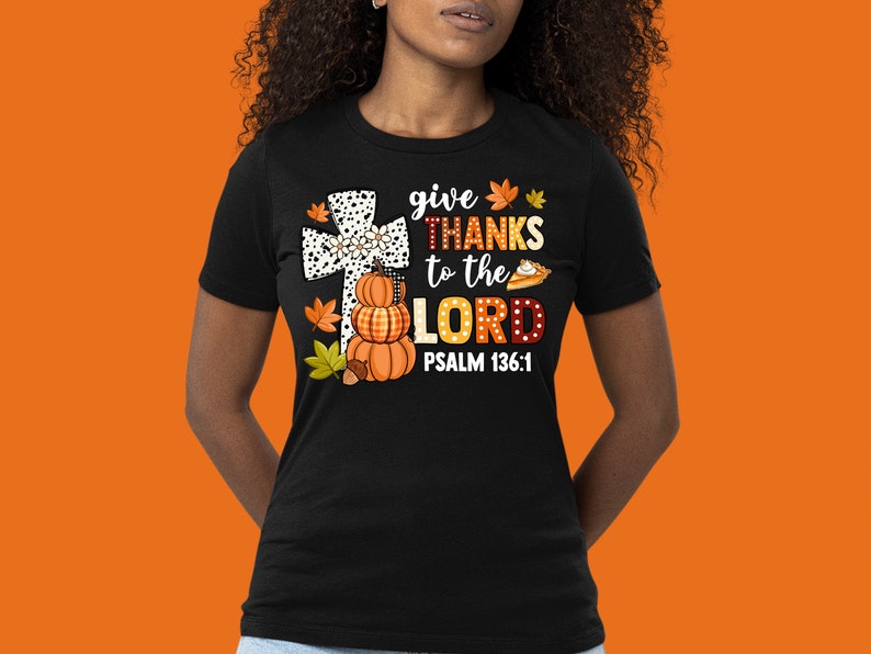 May include: Black t-shirt with a white cross, pumpkins, and a pie. The text reads "give THANKS to the LORD PSALM 136:1".