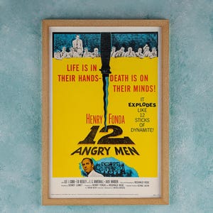May include: A vintage film poster for the movie "12 Angry Men" featuring a yellow background with a knife and the text "Life is in their hands - Death is on their minds!" and "It explodes like 12 sticks of dynamite!"  The poster also features the names Henry Fonda and Reginald Rose.