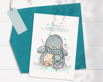 May include: A Christmas card featuring a cute cartoon penguin wearing a striped scarf and holding a small penguin chick. The card has the text "Merry Christmas" in a whimsical font.