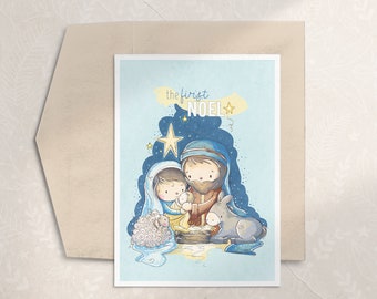 May include: A Christmas card with a blue background and a star. The card features a cartoon illustration of Mary, Joseph, and baby Jesus in a manger. The text "the first NOEL" is written in a whimsical font.