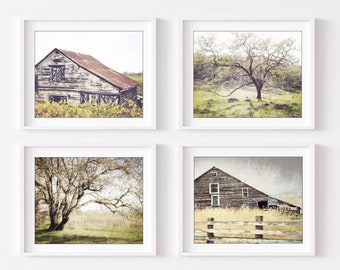 May include: A set of four framed wall art prints featuring rural landscapes. Two prints show weathered wooden barns with rusted metal roofs, and two prints depict large, bare-branched trees in open fields with soft, muted natural lighting.