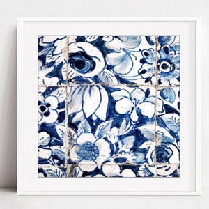 May include: A close-up of blue and white floral patterned tiles. The tiles are arranged in a grid pattern and have a distressed, vintage look.