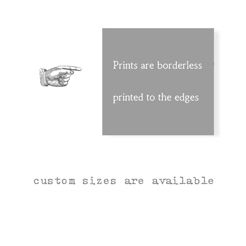 May include: A grey square graphic featuring the white text "Prints are borderless printed to the edges" with a black and white illustration of a pointing hand to the left. Below the square, the text "custom sizes are available" is displayed.