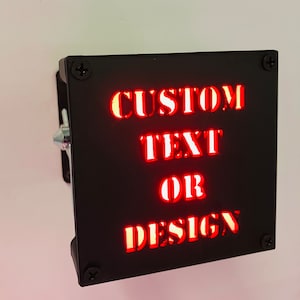May include: Black metal sign with red LED lights that says "CUSTOM TEXT OR DESIGN".