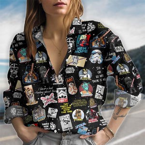 May include: A set of three ceramic mugs with a speckled, cream-colored glaze. Each mug features a different hand-painted design: a blue and green leaf, a yellow flower, and a red berry. The mugs have a simple, rounded shape.