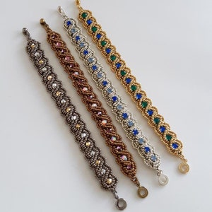 May include: Four beaded bracelets in different colours, including silver, gold, brown, and green. Each bracelet features a winding path design with blue gemstone accents. The bracelets are displayed on a white background with the text "Winding Path Bracelet Kit Smadar's Treasure © 2017".