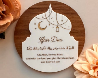 May include: A white wooden plaque with a gold-colored crescent moon and star design. The plaque has the words "Iftar Dua" and an Arabic prayer written in gold. The text below the prayer reads "Oh Allah, for you I fast, and with the food you give I break my fast, and I rely on you."