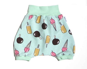 May include: Baby bloomers with a light blue background and a pattern of ice cream cones, popsicles, and chocolate-covered ice cream bars. The waistband and leg cuffs are mint green.