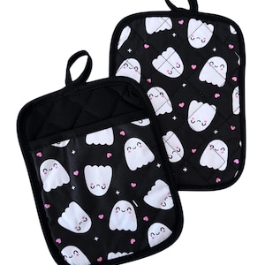 May include: A pair of black oven mitts with a white ghost and pink heart pattern.