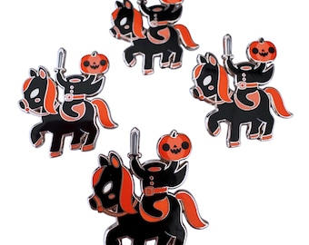 May include: Five black and orange enamel pins featuring a black knight riding a black horse, each holding a sword and wearing a pumpkin on their head.