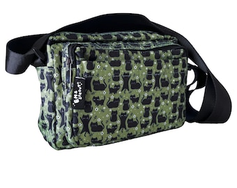 May include: A green crossbody bag with a black cat print and the text "EM & SPROUT" on the front.